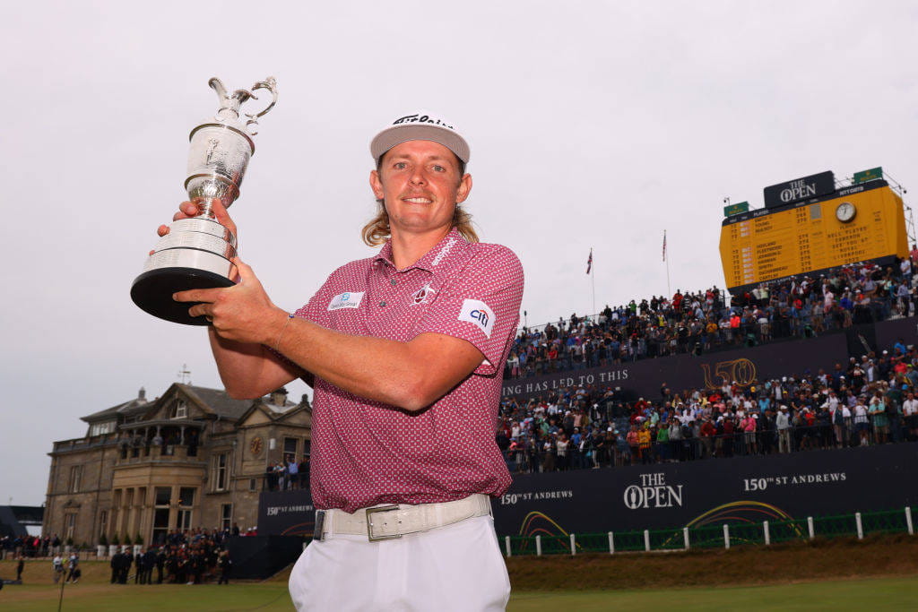 Cameron Smith poses with the Claret Jug in front of the grandstand at St Andrews